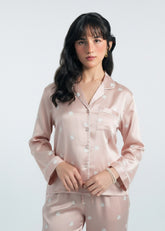 Female model wearing a larosa's pink satin pajama set with a white background - swan - best selling